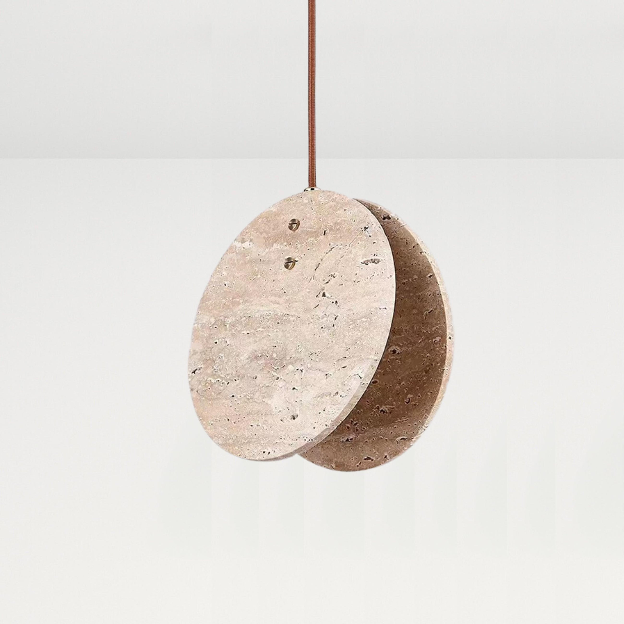 Nacre Travertine Pendant Light, featuring two round, hand-shaped stone discs with a brown cord.