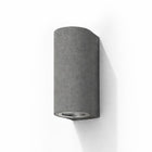 Blaze black sandstone outdoor up/down wall light with a curved cylindrical form.