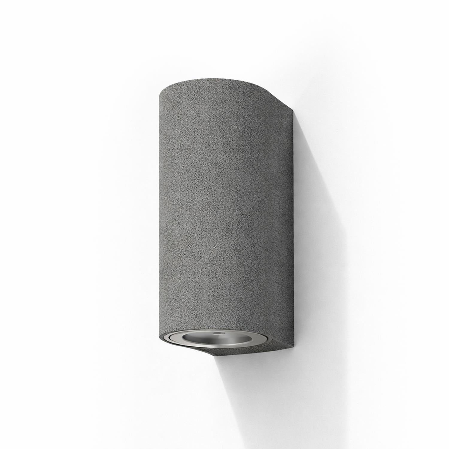 Blaze black sandstone outdoor up/down wall light with a curved cylindrical form.
