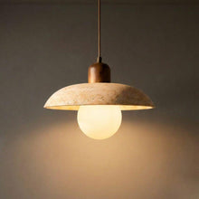 Flint natural stone pendant light with a light-colored, textured dome shade, walnut timber top, and glowing G9 globe.