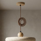Kaia natural stone pendant light with a circular textured stone shade, oak arm, and coiled brown cord.
