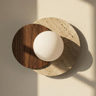 Lyra wall sconce with an opal glass orb on a natural stone base and walnut wood detail.
