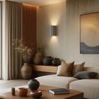 Terra Grey Concrete Up/Down Wall Light with fluted texture, illuminating a modern living room.